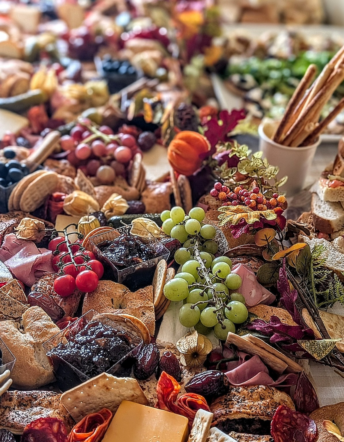 A generous grazing spread of breads, cheeses, fruit, cold meats and chutneys