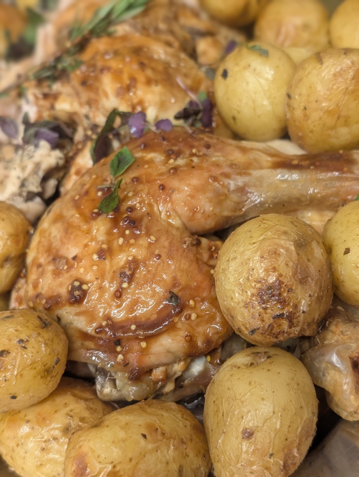 Golden roast chicken and potatoes prepared for sharing